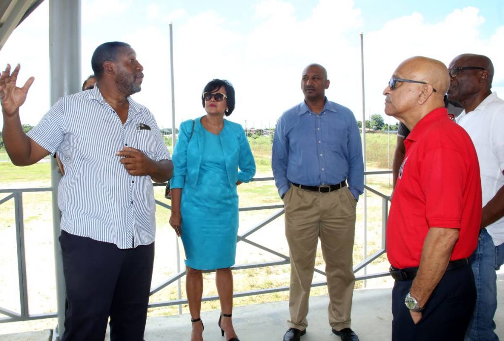 TTFA president David John-Williams, left, talks about the Home of Football project to representatives from other sporting bodies during a site visit last week in Balmain, Couva.