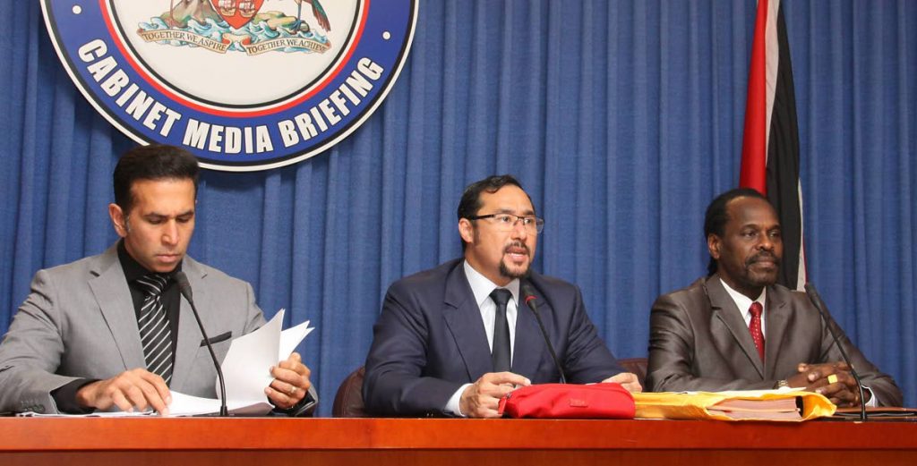 LEGAL BIRDS: National Security Minister Stuart Young, flanked by Attorney General Faris Al-Rawi and Minister in the Ministry of the AG Fitzgerald Hinds, addresses reporters at yesterday’s post-Cabinet media briefing at the Diplomatic Centre, St Ann’s.