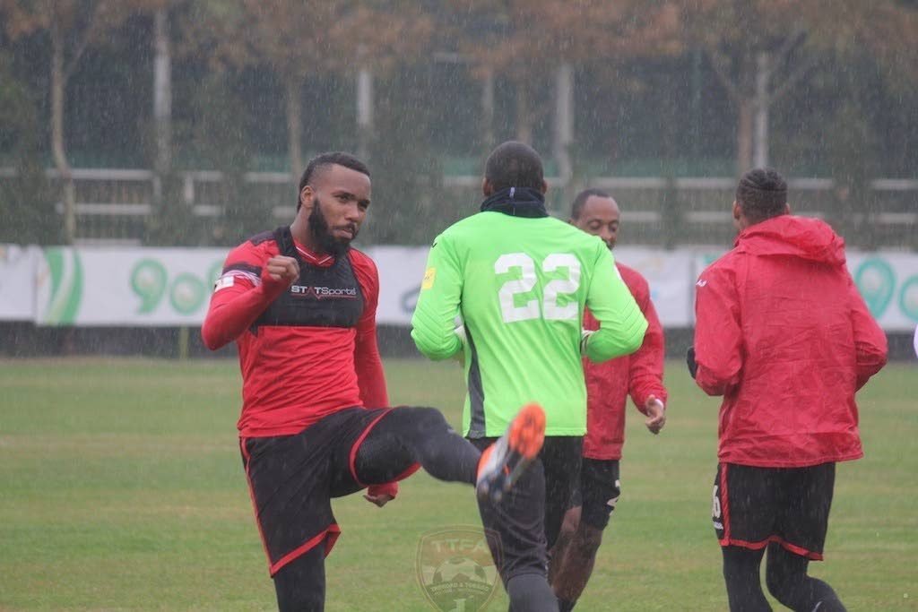 TT men’s football team captain Khaleem Hyland (left) warms up during a training session in Iran yesterday. Also in photo are Adrian Foncette (#22), Leston Paul (second from right) and Alvin Jones.