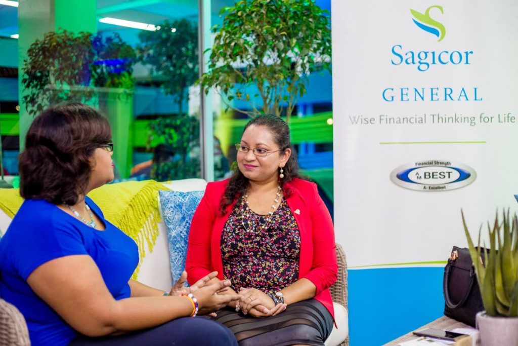 Two participants chat at the Sagicor Financial Café held at the Arthur Lok Jack Global School of Business on September 27 in this file photo. Sagicor is to be acquired by Canadian firm Alignvest the company announced in a statement on Tuesday.