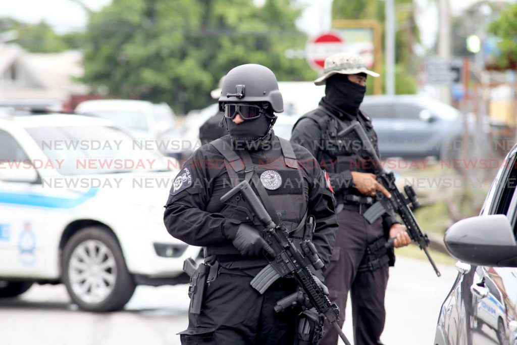 Members of the National Security special operations group stand watch outside the Chaguanas Magistrate Court as accused Jerome Oliverre attends court to answer charges of drug trafficking, arms and ammunition.  Photo by Lincoln Holder