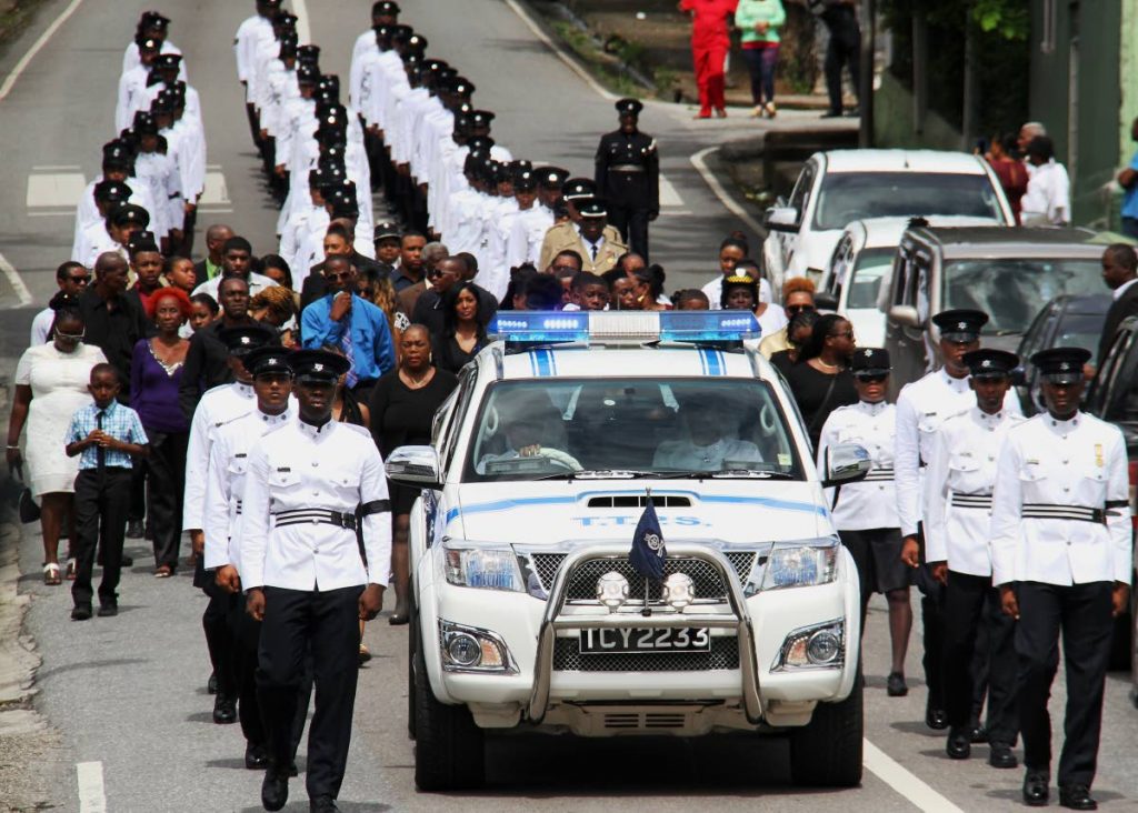 RIP: Colleagues and relatives of PC Rackel Kipps, who was murdered by her common-law husband PC Michael Youksee, escort her body to the cemetery after the funeral held at the St Joseph RC Church, St Joseph yesterday.