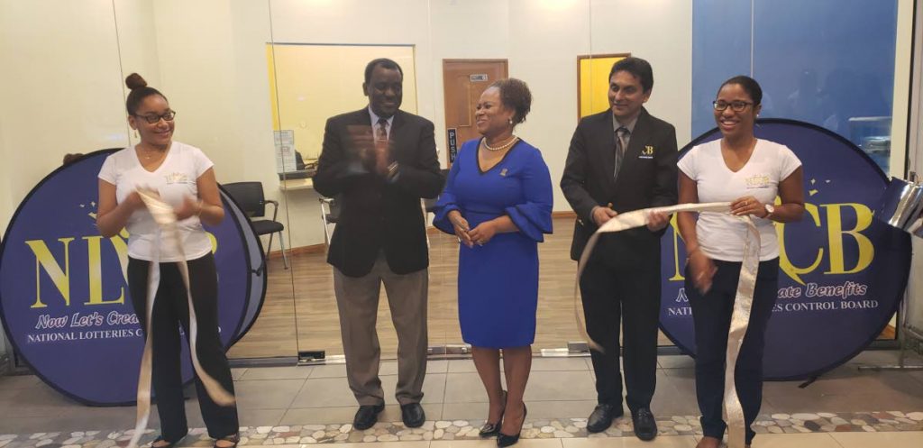 National Lotteries Control Board Directors Selby Browne, second from left, and Michael Jogee, along with Presiding Officer of the Tobago House of Assembly legislature, cut the ribbon to open NLCB’s first flagship story in Trinidad and Tobago at the Gulf City mall in Lowlands last Thursday.