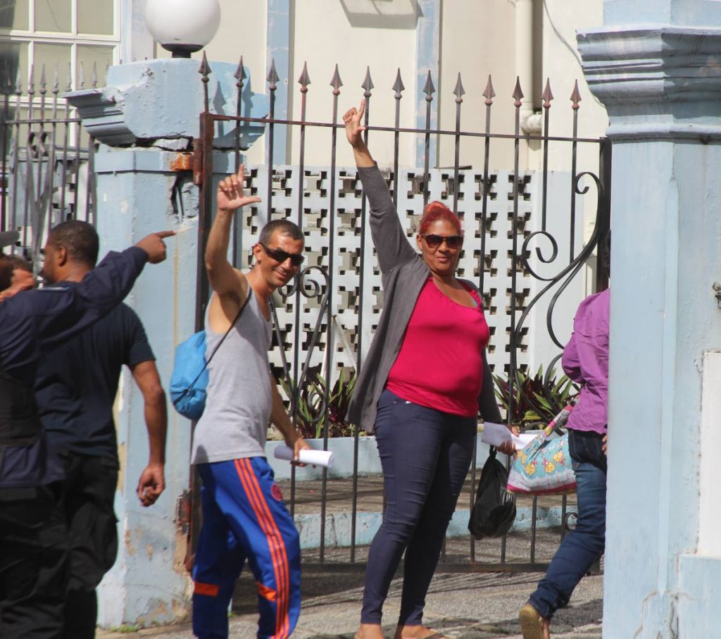 In this November 2018 file photo, Cuban asylum seekers who were arrested outside the United Nations office at Chancery Lane, Port of Spain wave as they arrived at the Port of Spain Magistrates Court.