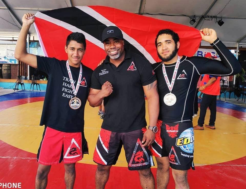 Aidan Ragoonanan (left) and Anthony Joseph (right) with their trainer Kerry Grant.