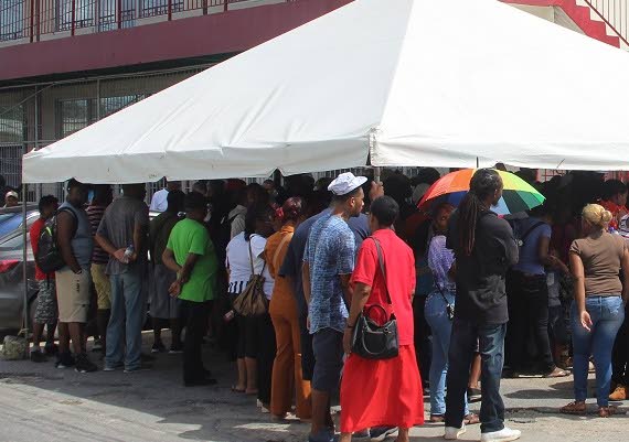 A crowd of applicants for flood relief grants at one of the assessment centres in Sangre Grande. Thirteen people including State officials have been charged with fraud relating to programme. FILE PHOTO