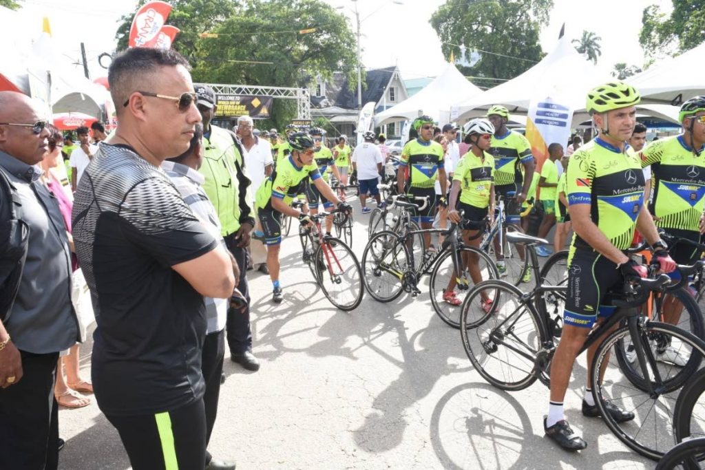 Commissioner of Police Gary Griffith (second from left) looks at a group of cyclists during the World Day of Rememberance for World Traffic Victims held Saturday at the Queen's Park Savannah. 