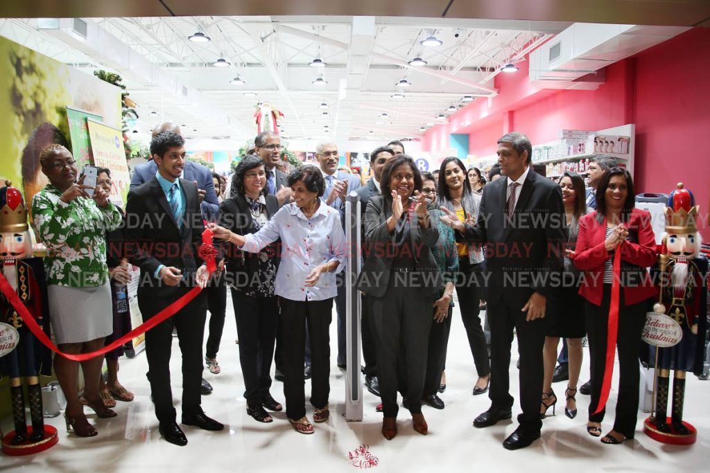 Pennywise Cosmetics opens at Long Circular Mall St James.
Minister of Trade Paula Gopee - Scoon and CEO/MD Dalvi Paladee celebrate following the ribbon cutting.
PHOTO BY AZLAN MOHAMMED
