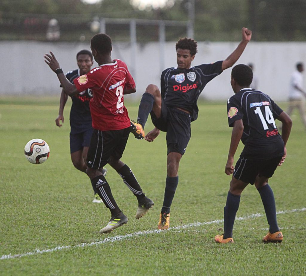 A QRC player tries to win the ball with a high challenge against St Anthony’s College in a North Zone Intercol semi-final yesterday at Fatima Grounds, Mucurapo.