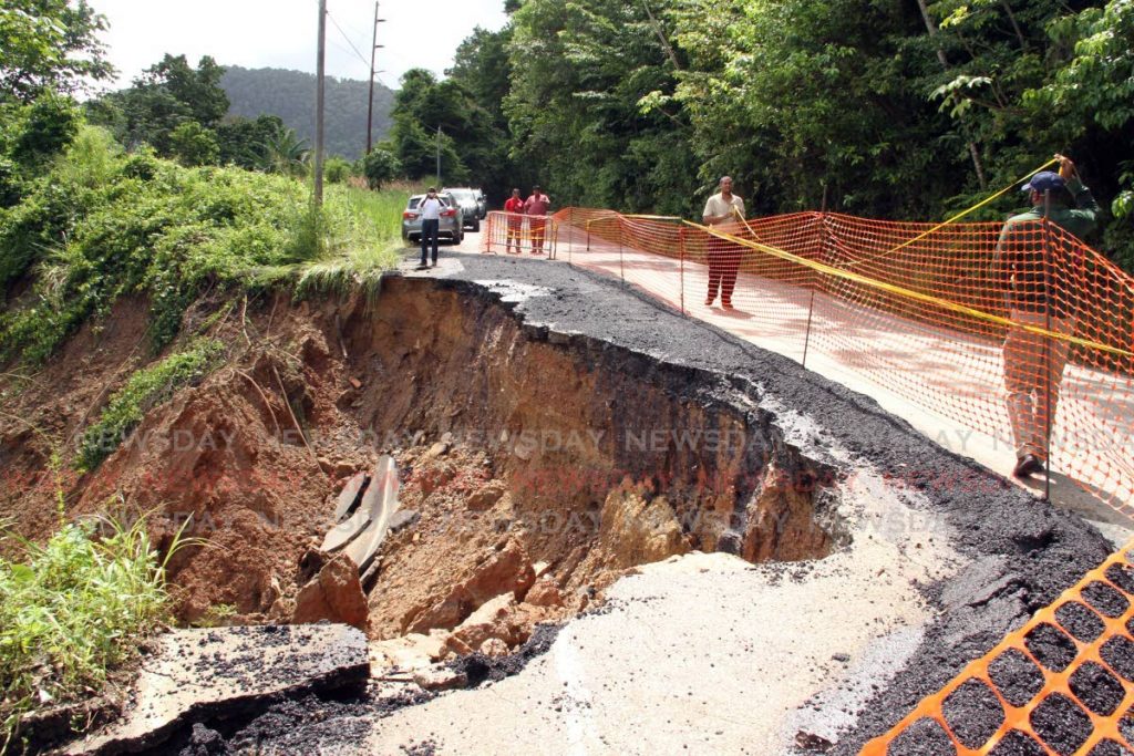 FLASHBACK: Back in September with officials of the Ministry of Works along the North Coast road just before Maracas beach where a hugh section of the roadway had slipped away. PHOTO SUREASH CHOLAI