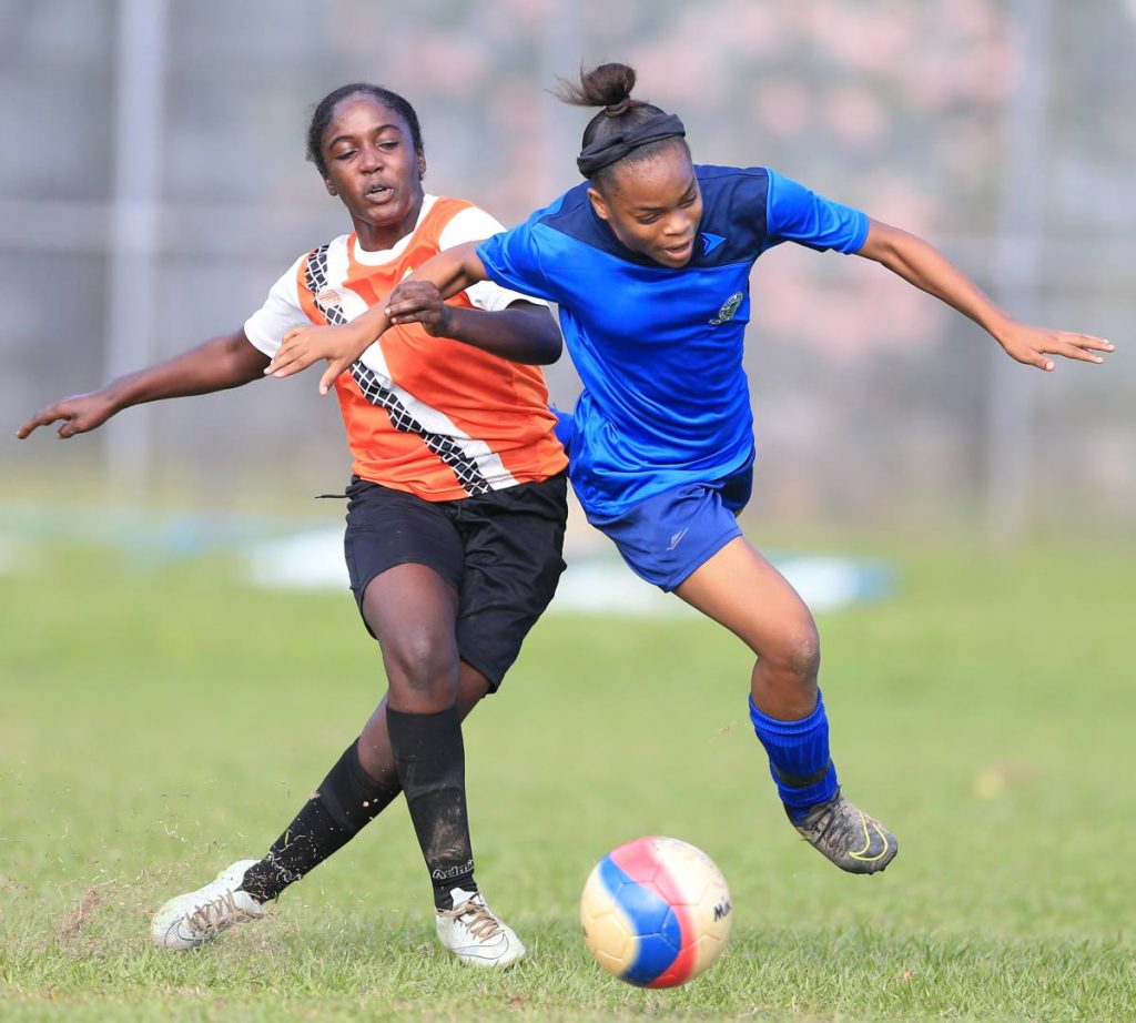 Five Rivers' goalscorer Mia Mitchell, right, is fouled as she blows past Valencia's Cyan Williams in the First Citizens SSFL Girls East Zone Final at St Augustine Secondary School ground, yesterday. 