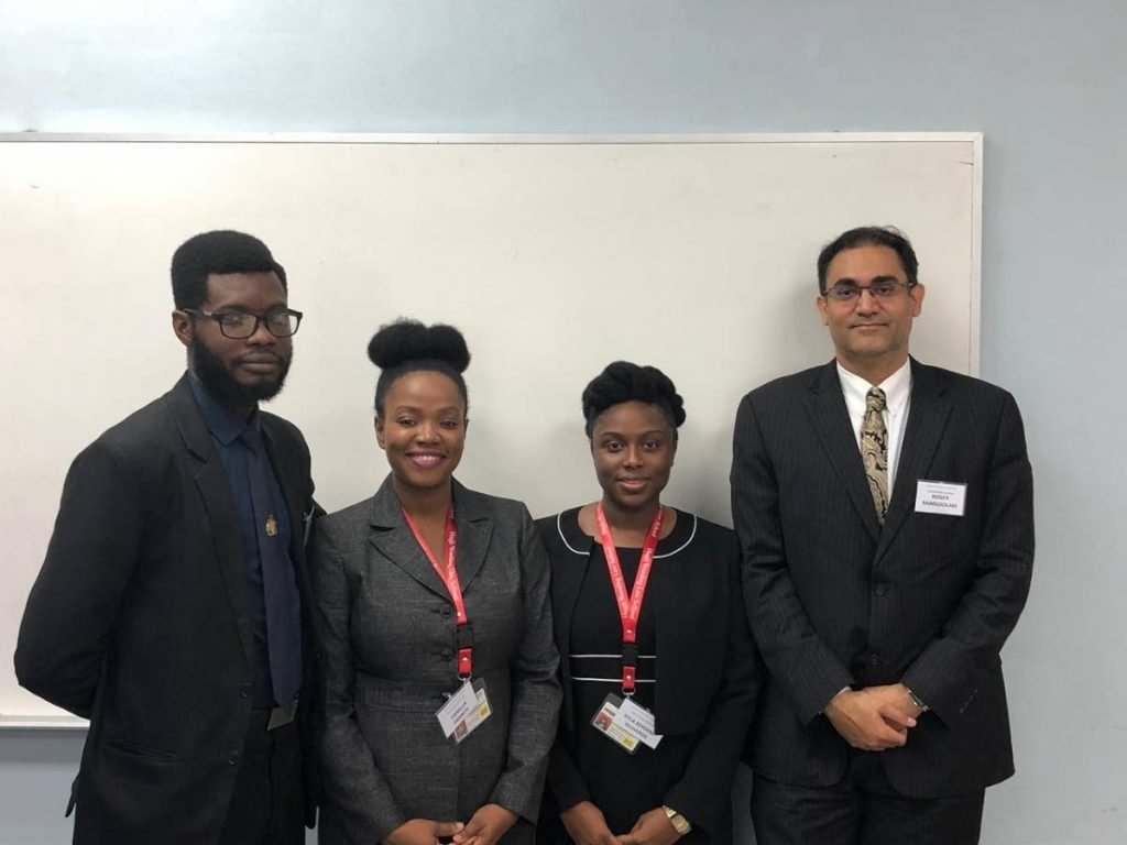 The winners of the Security and Exchange of T&T debate competition students Chevy Devonish, left,  Fanella Francis, Kyla Blackman and course director Roger Ramgoolam.
