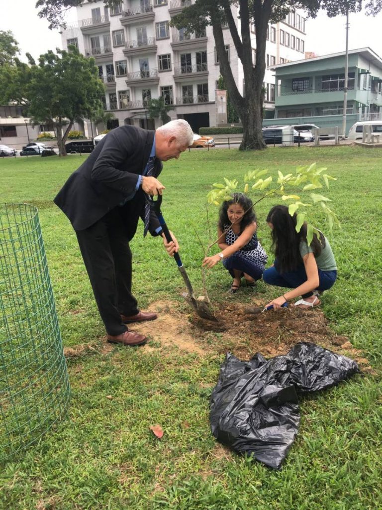 Mayor Joel Martinez joins in a tree-planting ceremony in memory of Richard Laydoo.