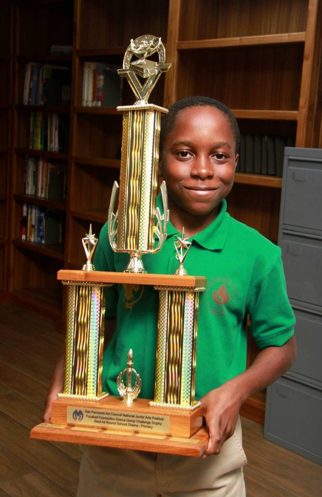 Marcus McDonald, a student of San Fernando Boys' RC Primary School, proudly displays the trophy he won at NGC Sanfest 2018 calypso competition.