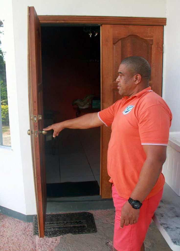 BEHIND PETRO DOLLARS: David Hospedales of Santa Flora points to his front door, which bandits broke before entering his house. PHOTO BY ANIL RAMPERSAD
PHOTO BY ANIL RAMPERSAD.