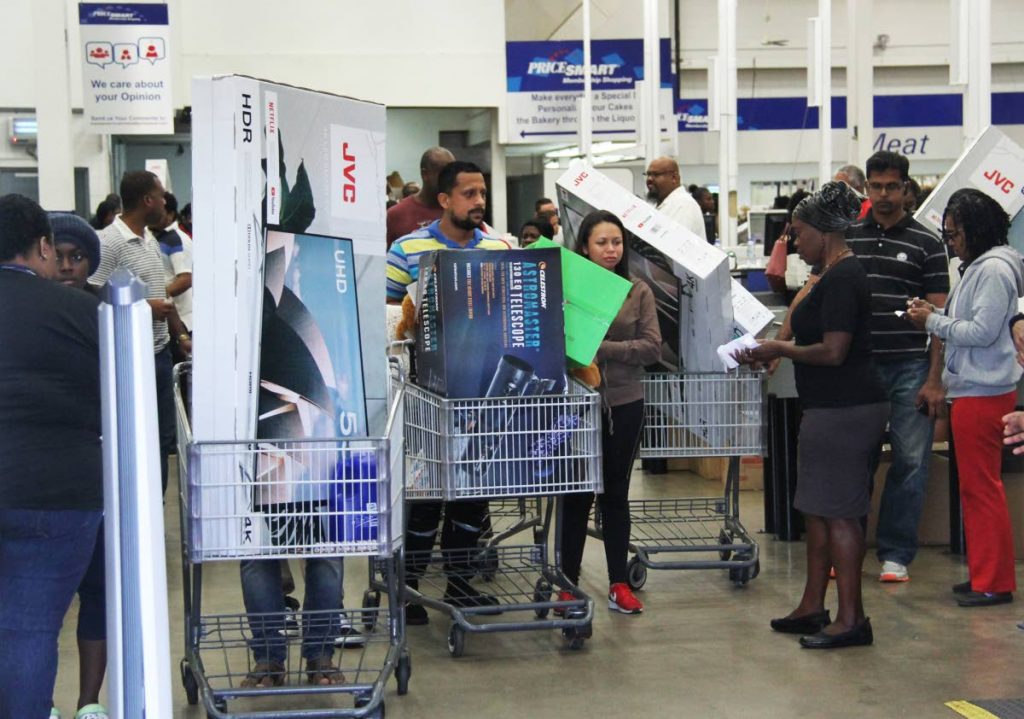TELEVISION CRAZY: Customers load trolleys with flatscreen TVs at PriceSmart in MovieTowne, Port of Spain as the nation engaged in frenzied Black Friday shopping, taking advantage of reduced prices. PHOTO BY SUREASH CHOLAI 