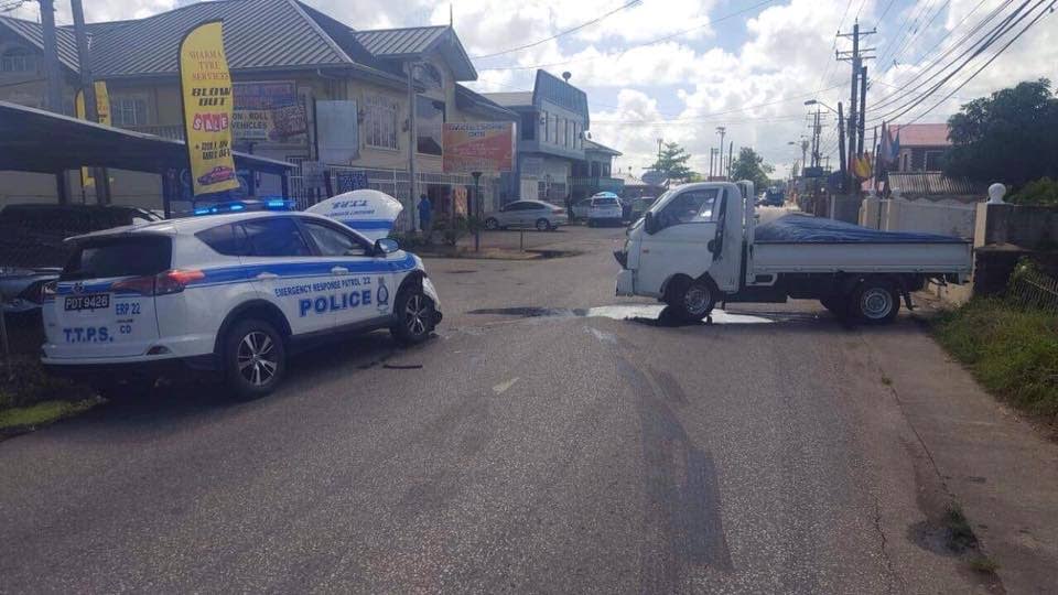 A police car and panel van that was involved in a collision at the corner of Munroe and Chin Chin Roads and Cunupia.