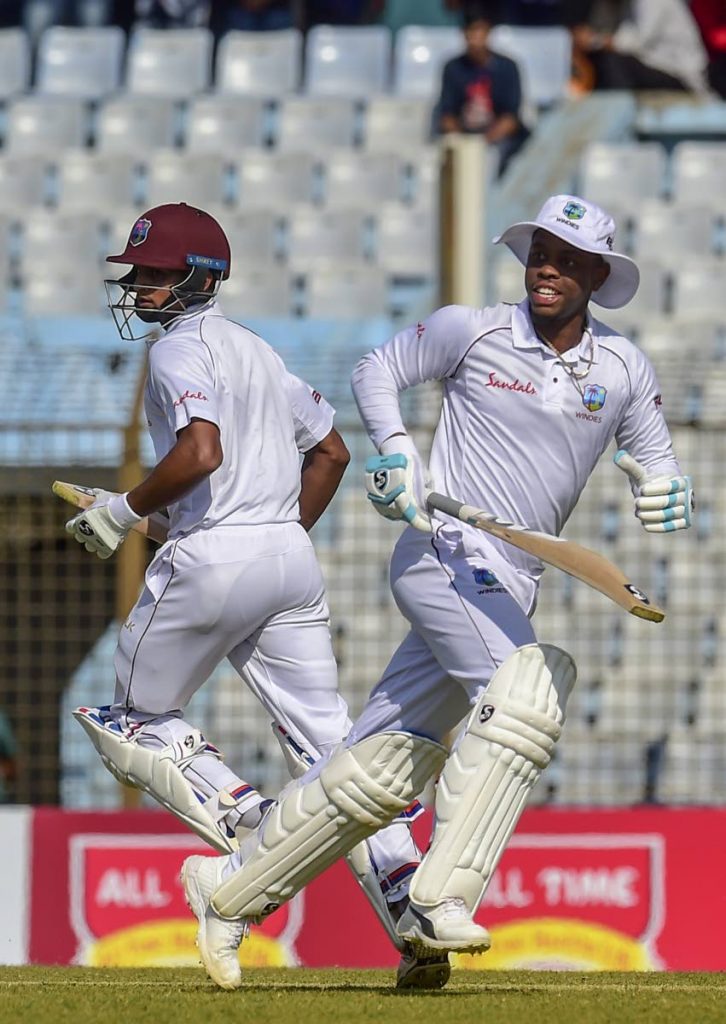 West Indies cricketer Shimron Hetmyer (R) and Shane Dowrich (L) run between the wickets during the second day of the first Test cricket match between Bangladesh and West Indies at the Zahur Ahmed Chowdhury Stadium in Chittagong yesterday.