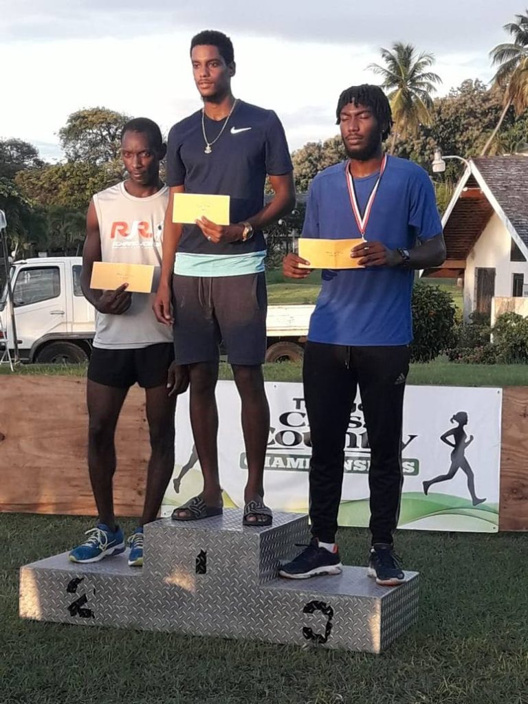 Tobago Cross Country champion Mark London of Zenith, centre, with second placed Elvis Turner, left, and third placed Kudane O'Connor. 
