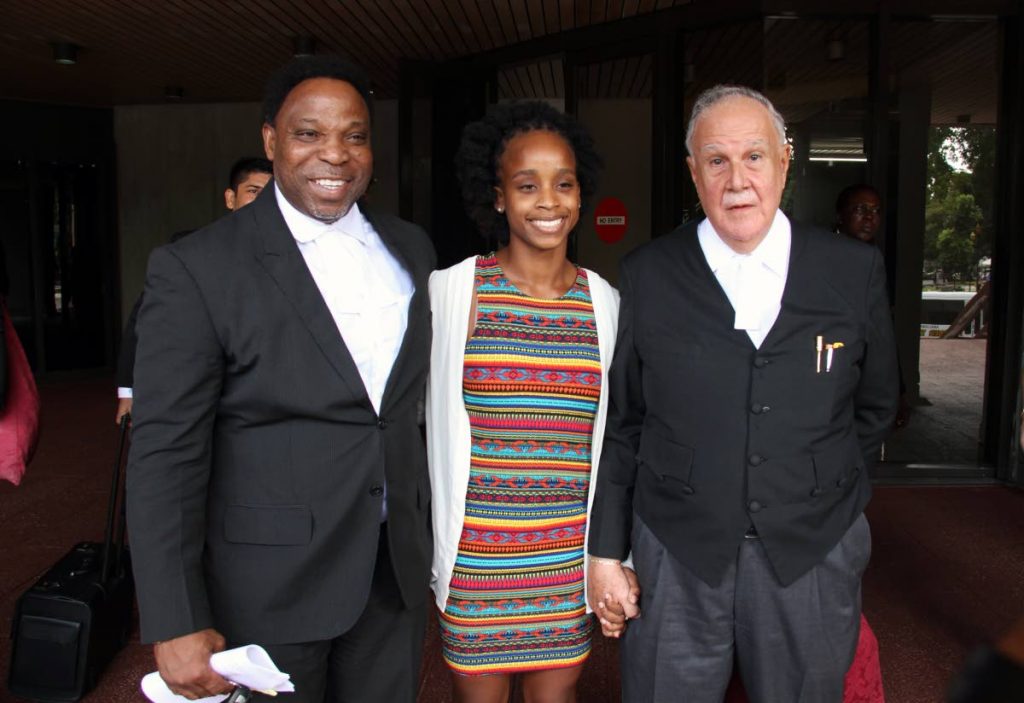 COURT WIN: Gymnast Thema Williams with her attorneys Martin Daly, SC, and Keith Scotland, left, at the Hall of Justice in Port of Spain yesterday. PHOTO BY SUREASH CHOLAI 