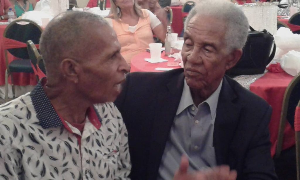 Bernard Julien (left) speaks to Sir Gary Sobers during Saturday’s Past Cricketers Society dinner and awards ceremony at the Queen’s Park Oval.