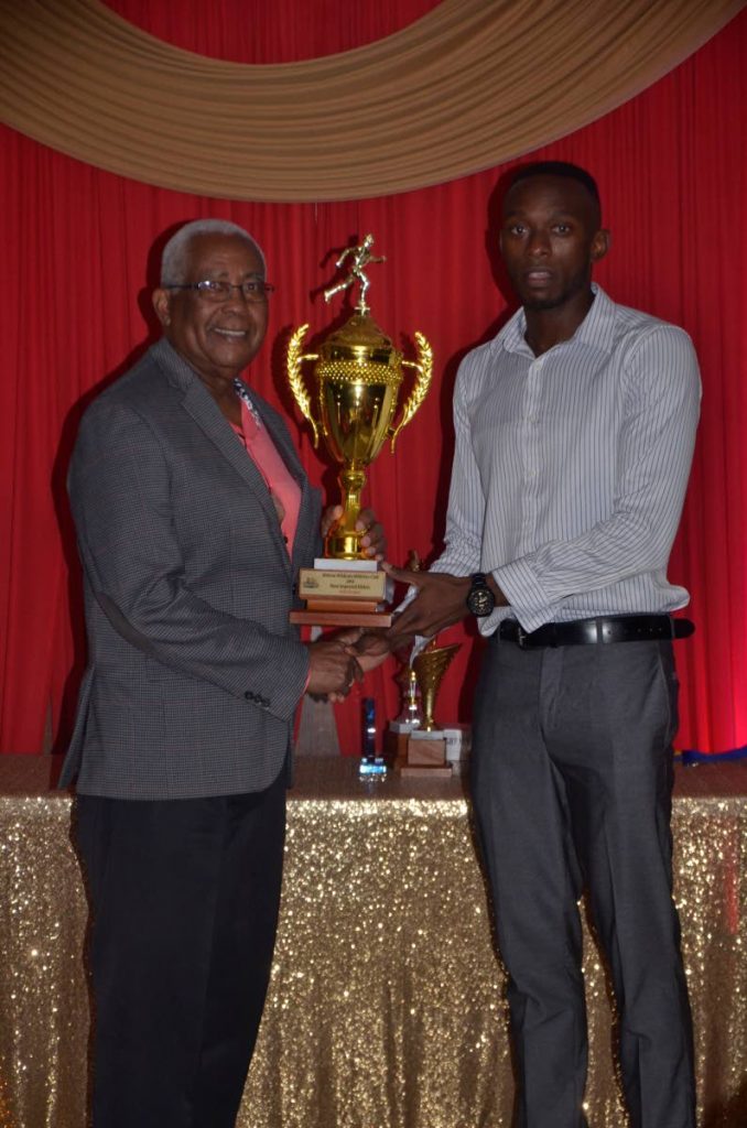 Kyle Greaux, right, collects Abilene Wildcats Athlete of the Year award from Minister of Education Anthony Garcia at the club's wards ceremony last weekend. (Photo by Clayton Clarke/Sportscore Tobago) 