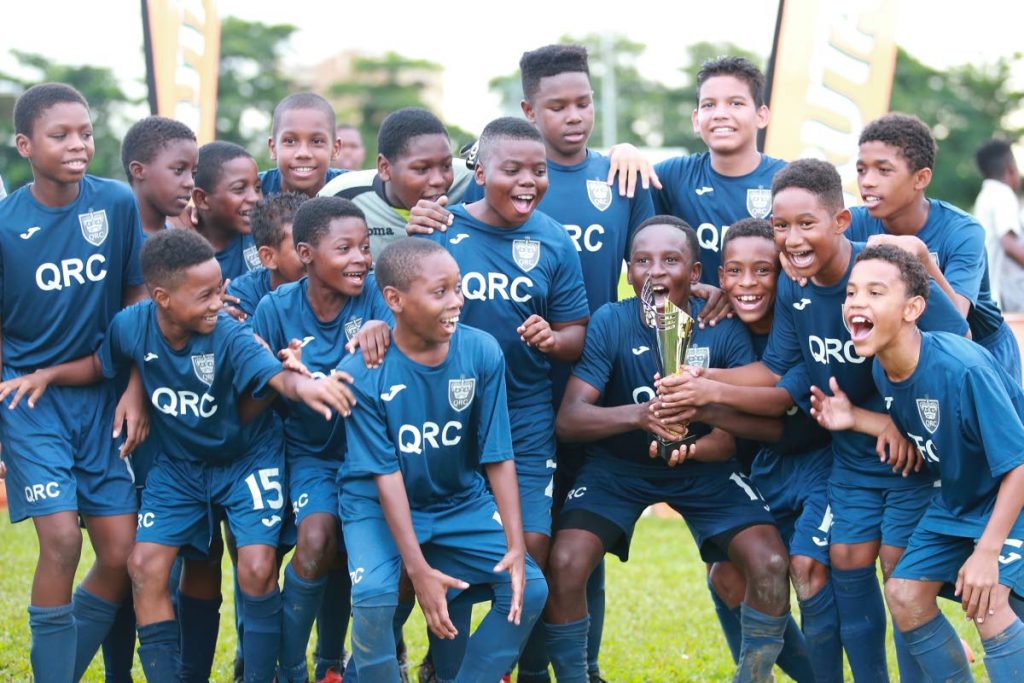 QRC Form one footballers celebrate after beating Fatima in the Fruta Form 1 League final yesterday at St Mary's Ground, St Clair. 