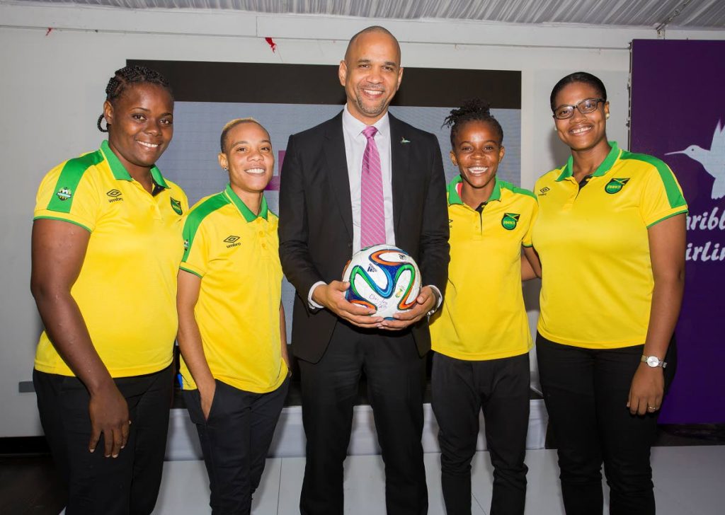 Caribbean Airlines CEO, Garvin Medera, centre, with members of the Reggae Girlz football team.