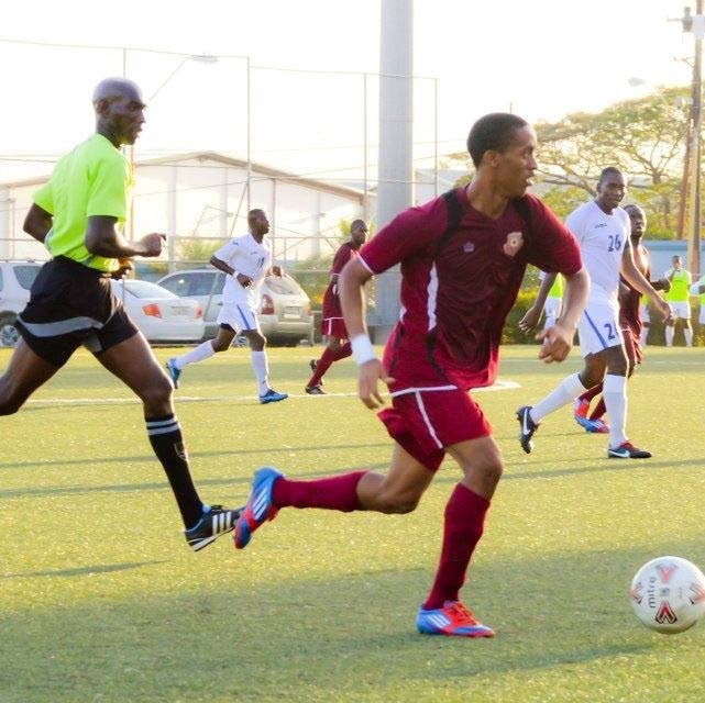 Deceased Marcus Gomez (right) on the ball for former club North East Stars during a Pro League match at the Marvin Lee Stadium, Macoya several years ago. 