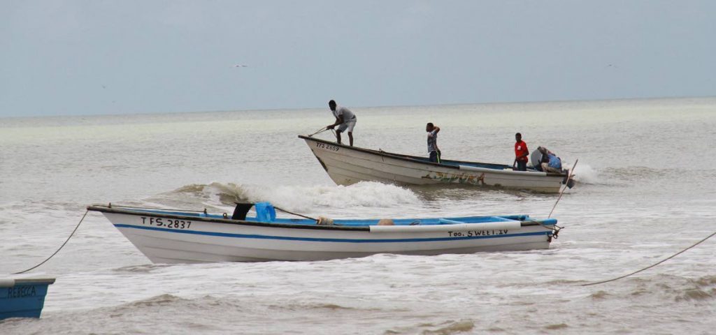 In this February 2018 file photo, fishermen head out to sea off the coast of Erin. 