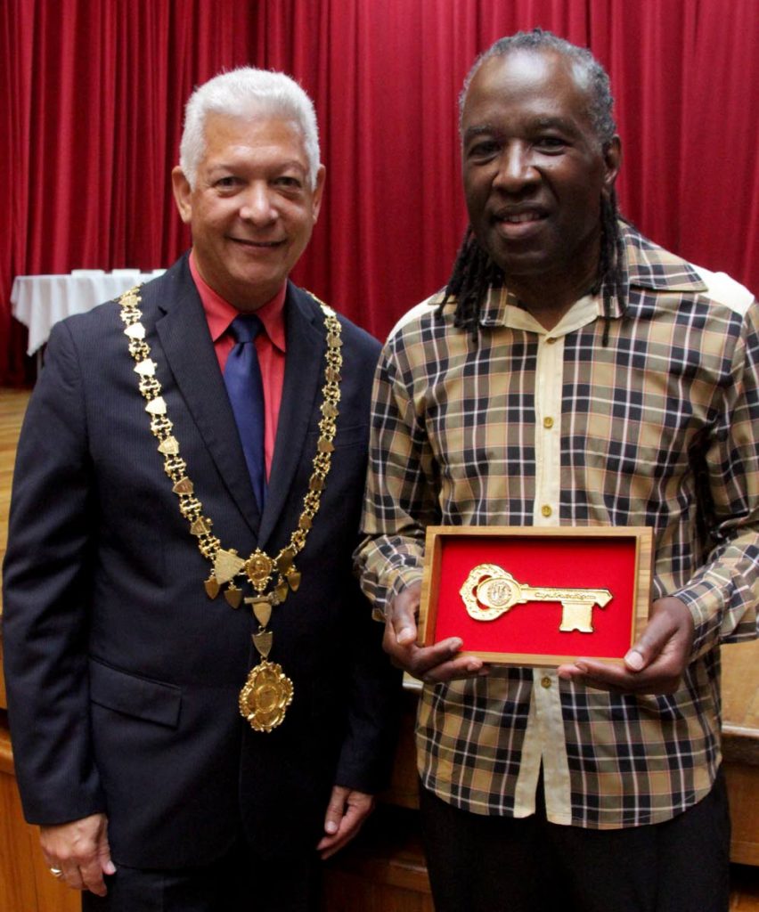 David Rudder, right,  holds the keys to the city of Port of Spain presented by Port of Spain Mayor Joel Martinez.