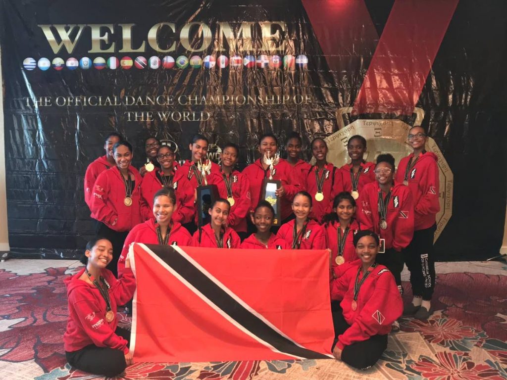 The group of 18 in the  12-17-year-old category with two of the three trophies won by the the Caribbean School of Dancing.