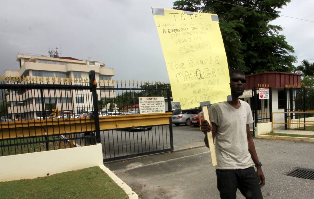 Kevin Julien, suspended T&TEC employee protesting outside offices of T&TEC, Stanley Ottley Building, Mount Hope, yesterday.