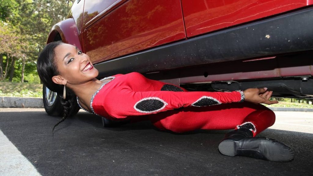 Guinness World Record holder Shemika Charles-Campbell limbos under a car in the US in 2018.

 PHOTO: RUARIDH CONNELLAN/BARCROFT USA