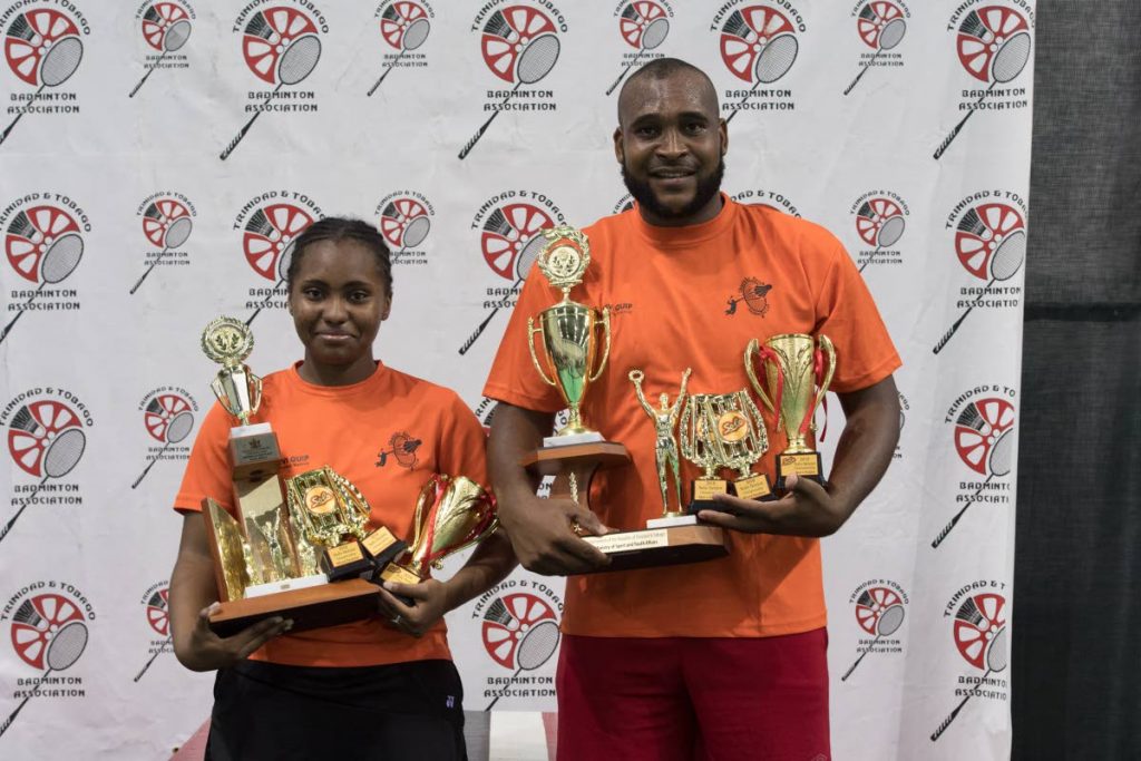 Shuttle Force pair Chequeda de Boulet, left, and Allistair Espinoza pose with their head of awards following the TT Badminton Association’s Solo Seniors Tournament, which closed at the National Racquet Centre, Tacarigua, Friday night. The duo both won their singles and doubles events before pairing up to win their triple crowns in the mixed doubles final.