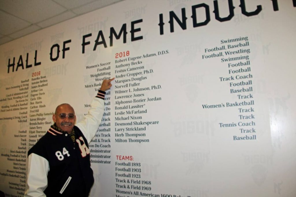 Dr Andre Cropper points to his name after being inducted into Howard University’s Athletic Hall of Fame.