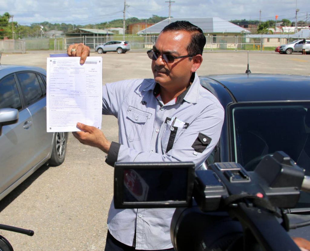 Councillor and former Petrotrin worker Shankar Teelucksingh  shows his Inland Revenue form,  which he received from the Inland Revenue Office on Monday.