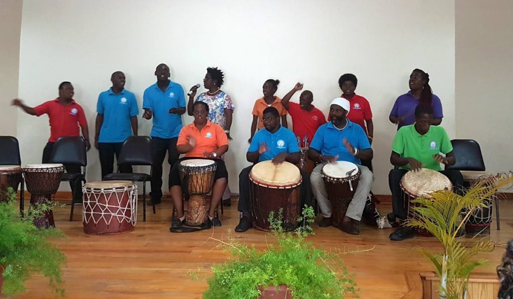 Students from TECVOC perform an item, accompanied by their teacher, Dotsie Bachus, back row, fourth from left, and drum instructor Courtney Potts, front row, second from right, at an observance of International Day of Persons with Disabilities.at the Canaan/ Bon Accord Community Centre on Monday.