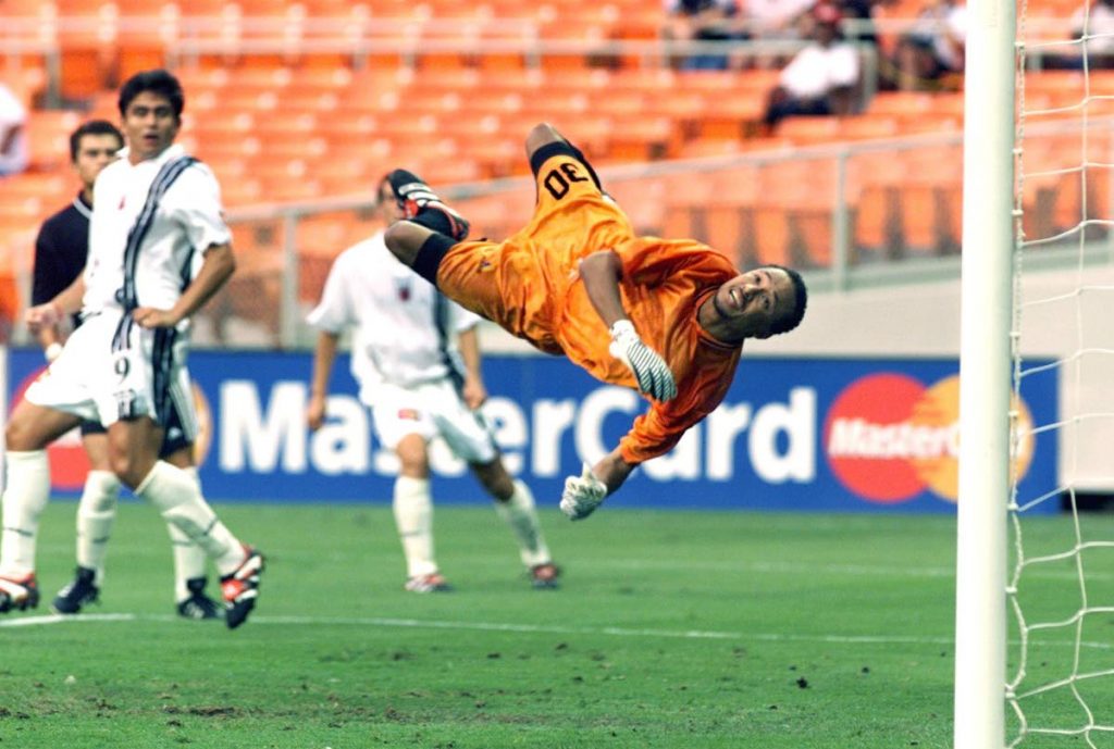 Then Joe Public FC goalie Michael McComie (right) dives to stop a shot while DC United forward Jamie Moreno (left) looks on during the first half of the 1999 CONCACAF Club Championship quarter-final match at the RFK Stadium in Washington, DC, US.