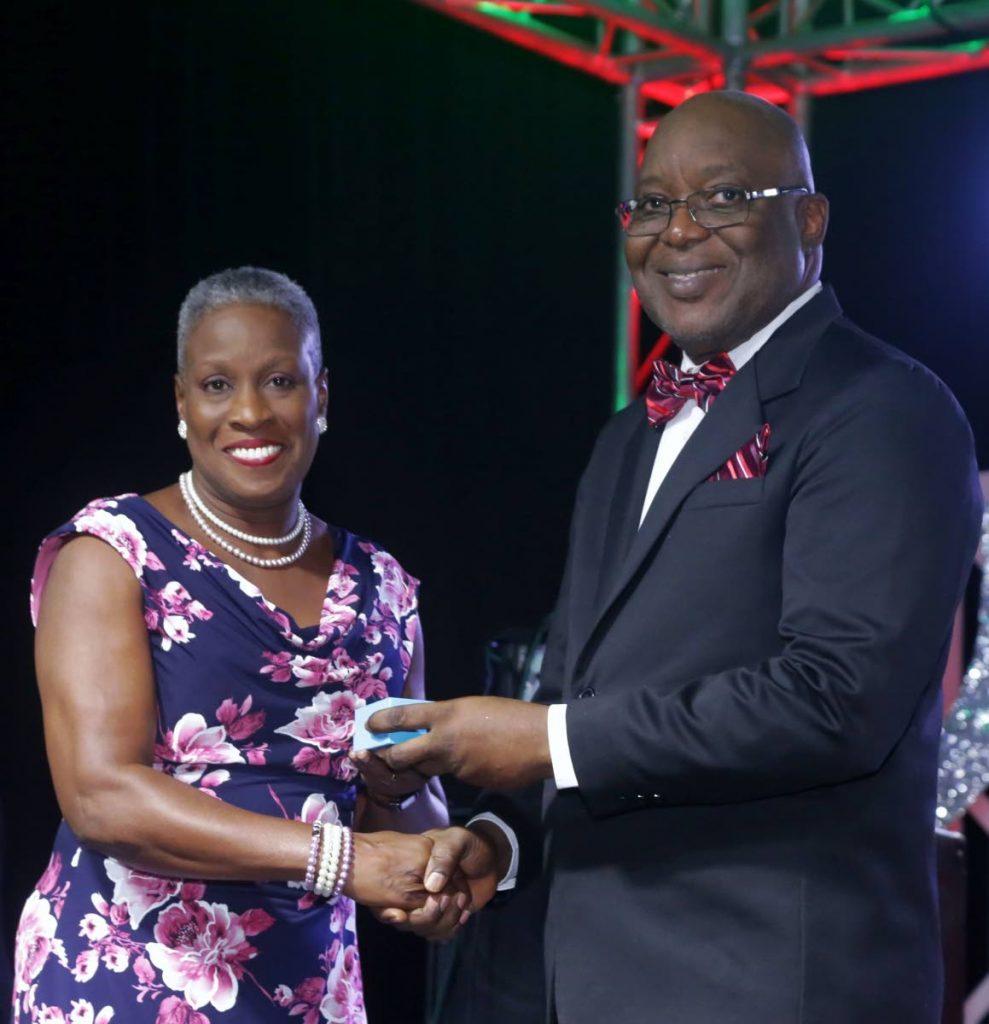 On behalf of Gywneth Armstrong, who received the Tobago Medal of Honour (Gold) for distinguished and outstanding service to Tobago in the sphere of Music, niece Merna Edwards receives the award from Chief Secretary Kelvin Charles at Tuesday night’s Tobago Day Awards ceremony hosted by the Tobago House of Assembly at the Auditorium of the Shaw Park Cultural Complex.