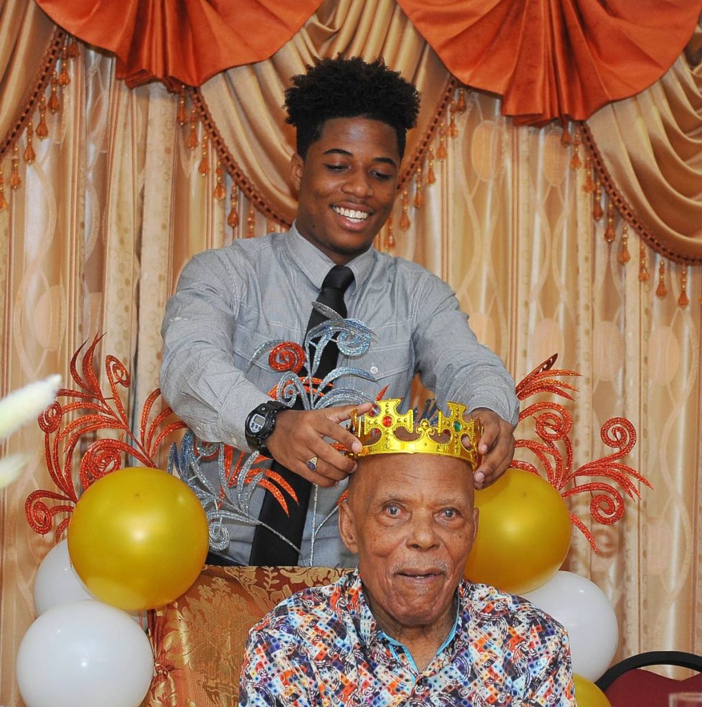 Justin McLeod places a crown on his grandfather Stephenson Callender.