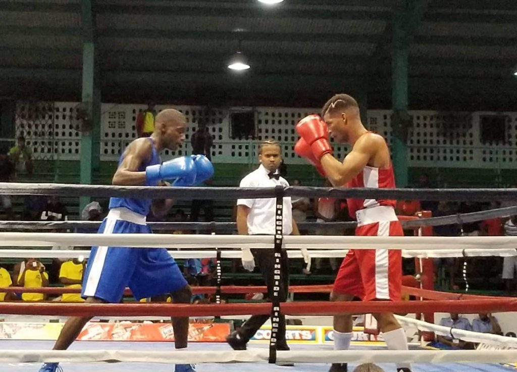 TT boxer Michael Alexander, right, puts his guard up against Guyana's Colin Lewis in a lightweight bout at the Caribbean Boxing Championships at the Cliff Anderson Sports Hall, Guyana, Friday. 