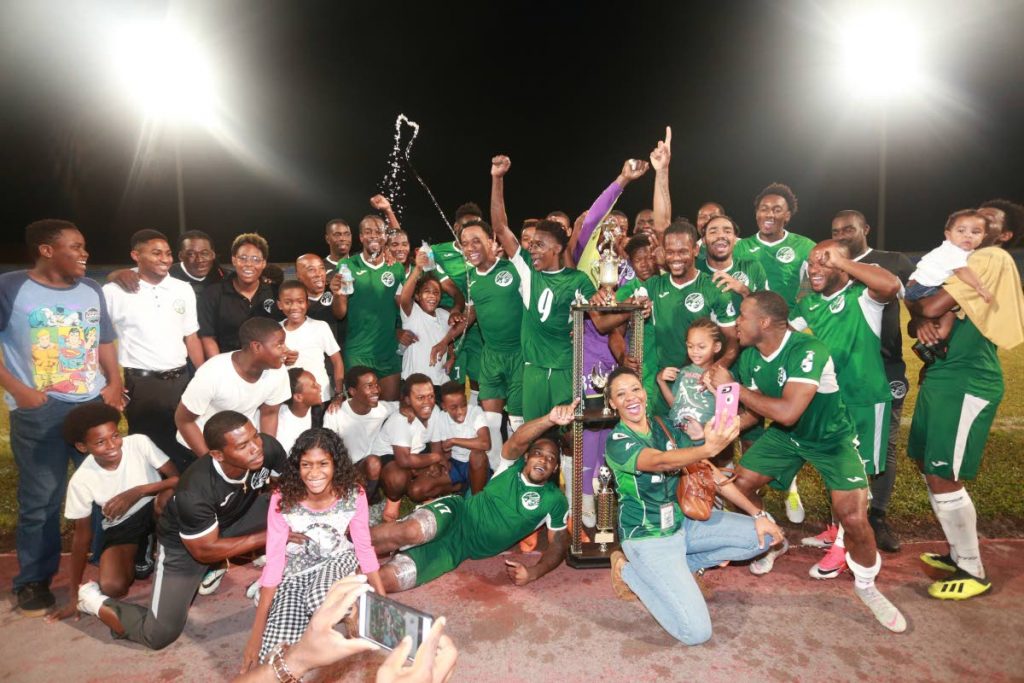 SWEET VICTORY: W Connection players, technical staff and supporters celebrate with theTT Pro League trophy after beating North East Stars 4-0 on Friday night at the Ato Boldon Stadium, Couva. PHOTO BY Allan V Crane/CA-images