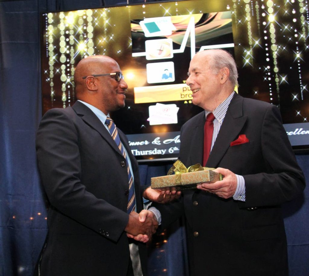 SUITE NO MORE: TSTT senior manager (public relations) Graeme Suite, left, was last week handing out tokens including this one given to Peter Ames at the TTPBA's media excellence ceremony at Jaffa's at the Oval. On Tuesday, Suite was among 51 TSTT employees to be retrenched. PHOTO BY SUREASH CHOLAI 