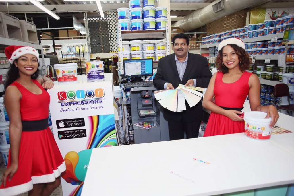 Kaleidoscope Paints Ltd CEO Dale Parson and Kaleidoscope representatives at the launch of the Kolor Expressions kiosks at Bhagwansingh’s Hardware, Sea Lots, Port of Spain on December 12.