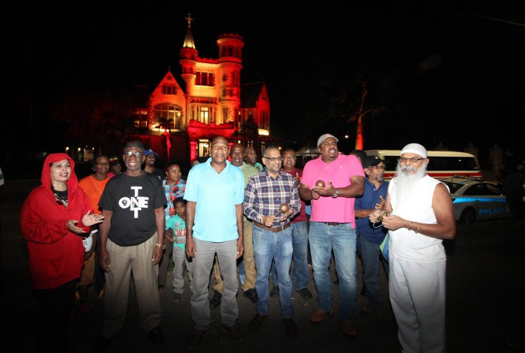 Former government minister Devant Maharaj, centre, and a small group of protesters 