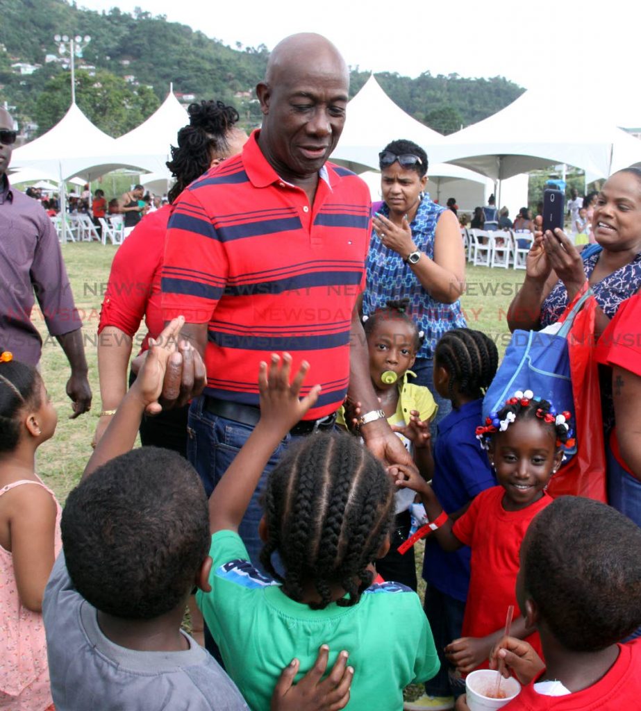 Prime Minister Dr Keith Rowley greets children at his Diego Martin West constituency children’s Christmas party at Four Roads Recreation Ground, La Puerta yesterday. PHOTO BY ANGELO MARCELLE