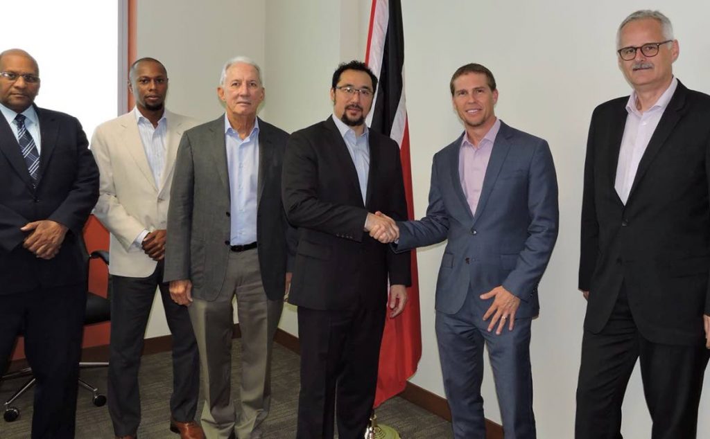 Communications Minister Stuart Young, fourth from left, shakes hands with SRI deputy chairman Adam Stewart at a meeting to discuss the Sandals Tobago project.  Third from left is Petrotrin’s Chairman Wilfred Espinet.