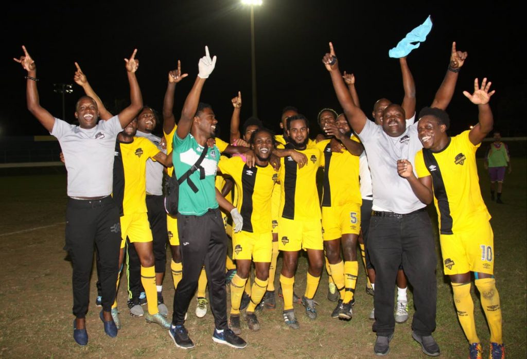 Cunupia FC players and technical staff celebrate victory in the TT Super League Cup final last weekend at the Arima Velodrome.