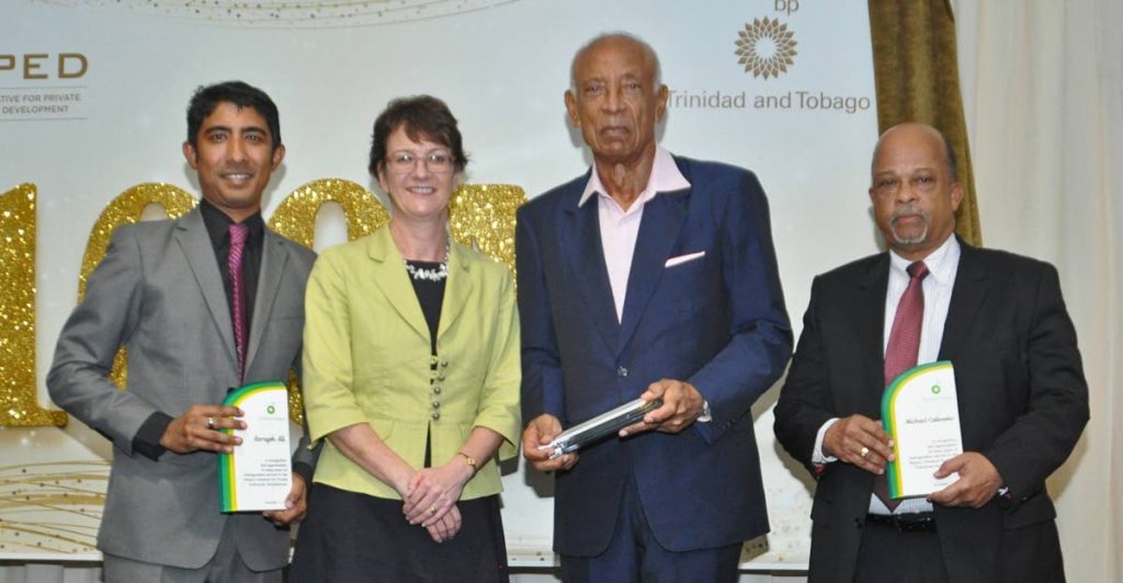 Former MIPED directors Richard Callender, right, and  Ken Gordon  with  their Awards of Recognition presented by Claire Fitzpatrick, regional president, BPTT and  Miped manager Rory Jitta.